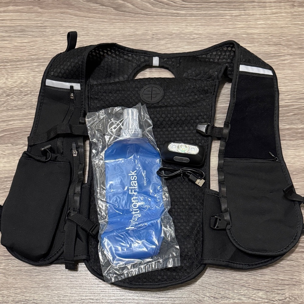 Black Running Vest Backpack with Blue Hydration Flask and LED light